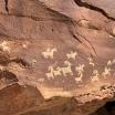 rock face with petroglyph depicting four-legged horned animals