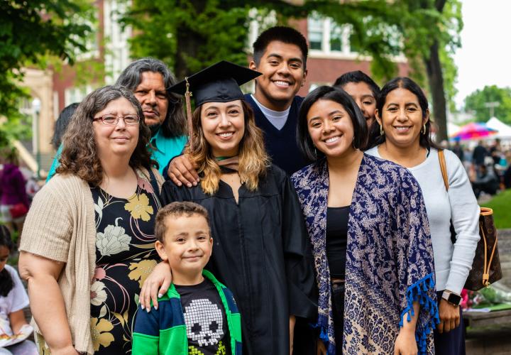 Graduate student posing for picture with multi-generational family members