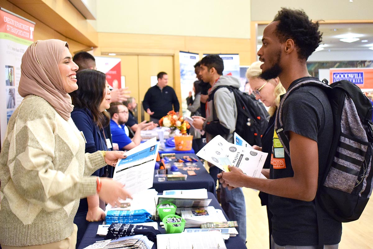 Recruiter talking with student at career fair