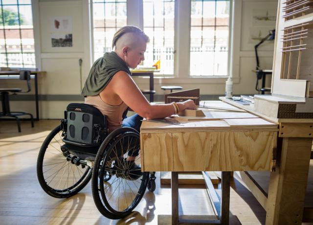 Person in a wheelchair working on a project