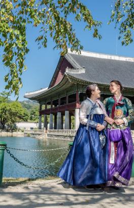 Two PSU students in traditional Korean dresses in front of a temple