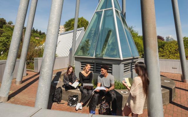 Students hanging out and studying together on rooftop garden