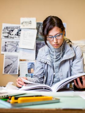 student with open book studying at desk