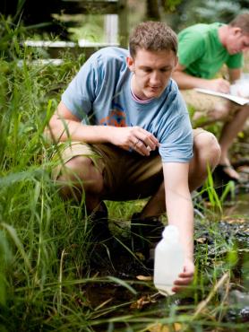 Student collecting data from a stream