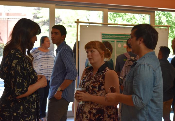 A faculty chats with two students at New Student Orientation