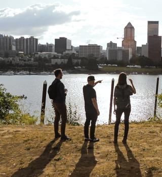 Portland skyline behind Geography faculty and students.