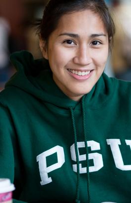 PSU student smiling on campus.