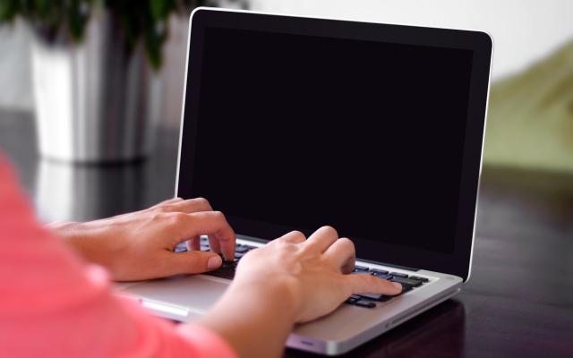 This photo is decorative. A person typing on a computer.