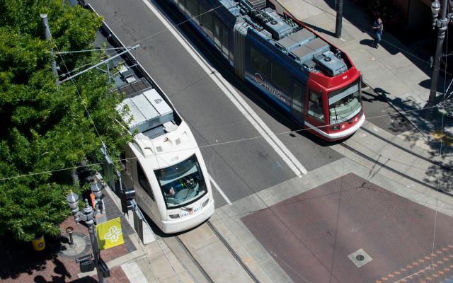 overhead photo of two max trains on the street