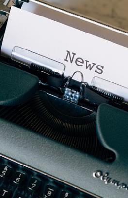 Typewriter with paper on the roller that says "News"