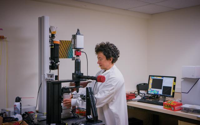 Physics professor in lab with microscope