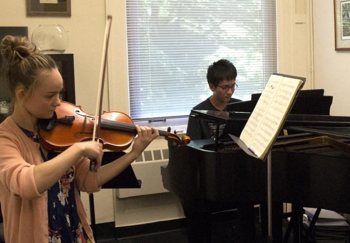 Piano and violin students in rehearsal