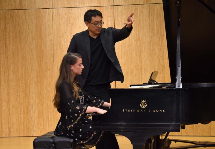 Master pianist Melvin Chen gives instruction to a piano student durign a master class.