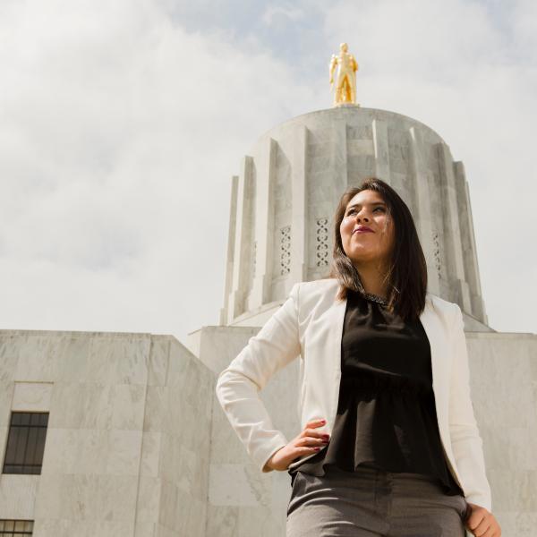 Woman standing on the steps of the Oregon state capitol building