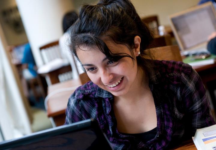 Close-up of student looking at laptop in library