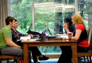 Group of four students studying at library