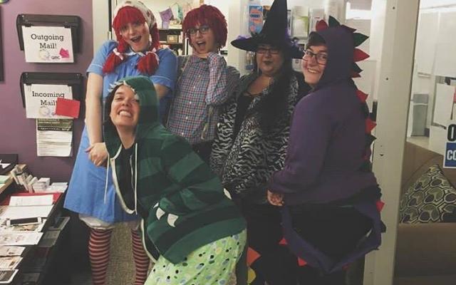 5 quer people dress up for halloween as Ragady Ann, Ragady Andy, 2 dinosaurs, and a witch