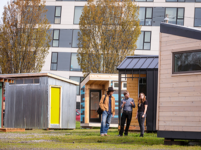 Portland State University professor and two students working on a tiny house project