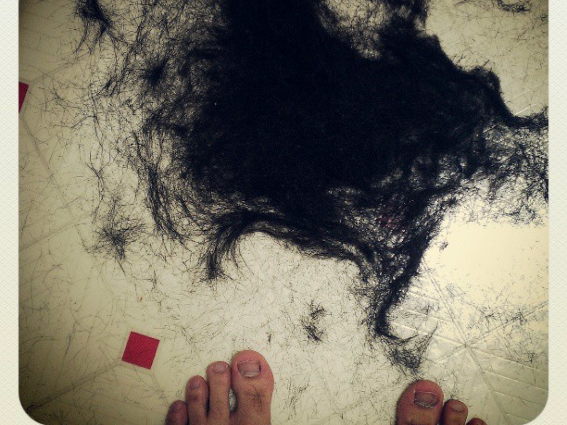 There is a pile of black hair on the floor.