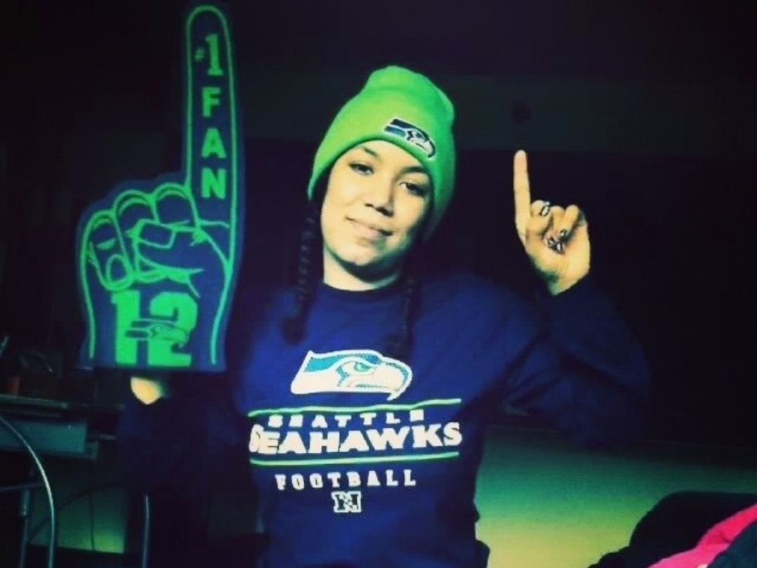 There is a person wearing Seattle Seahawks gear. 