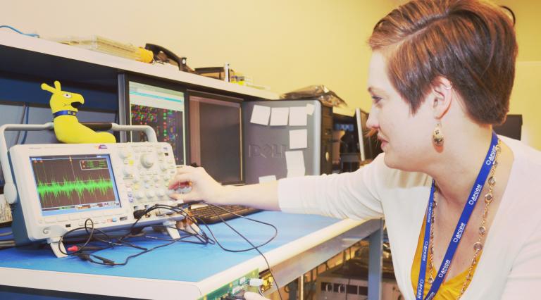 A student turning knobs on a computer