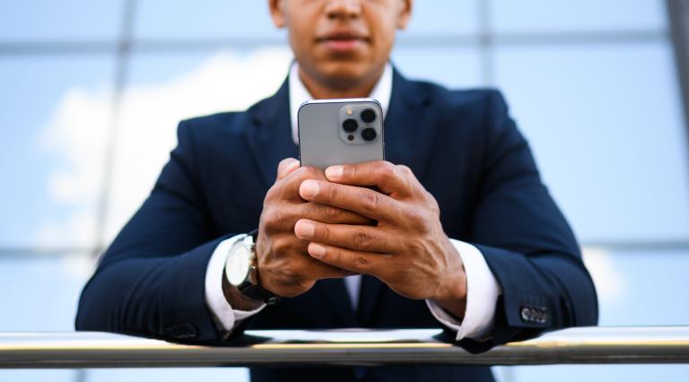 man in suit looking at phone