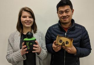 Two students holding a three-sixty camera and Google cardboard.