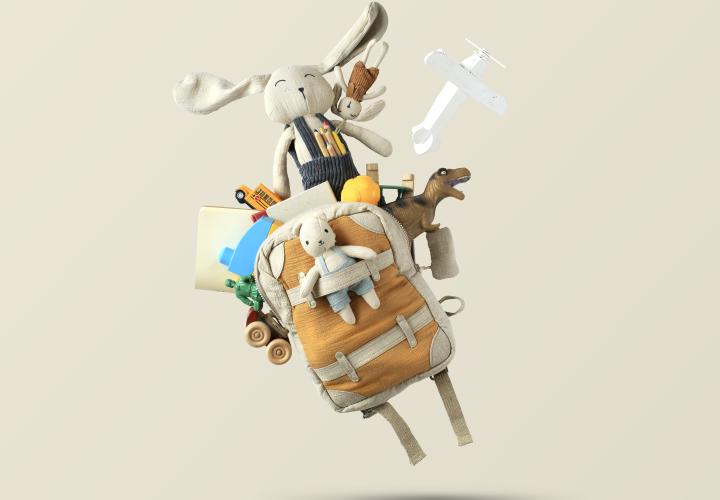 Stylized image of a backpack filled with toys and stuffed animals launching off of the ground.