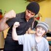 a student and child flex their muscles togehter