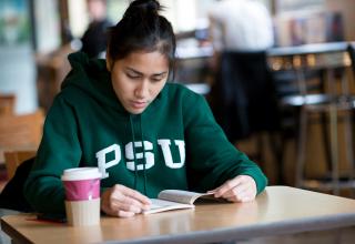 girl in PSU sweatshirt reading