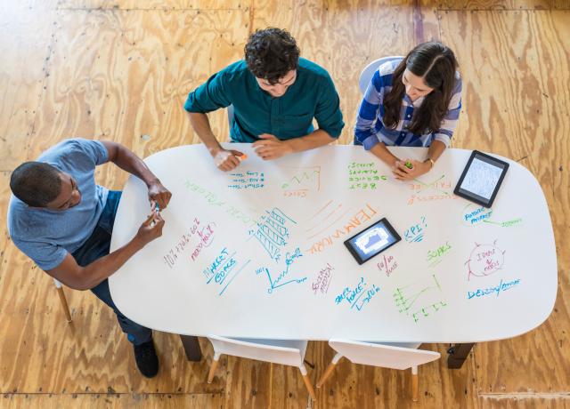 Students brainstorming at a table
