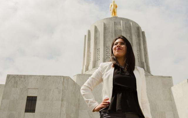 An alumna stand proudly outside the state capitol in Salem. 