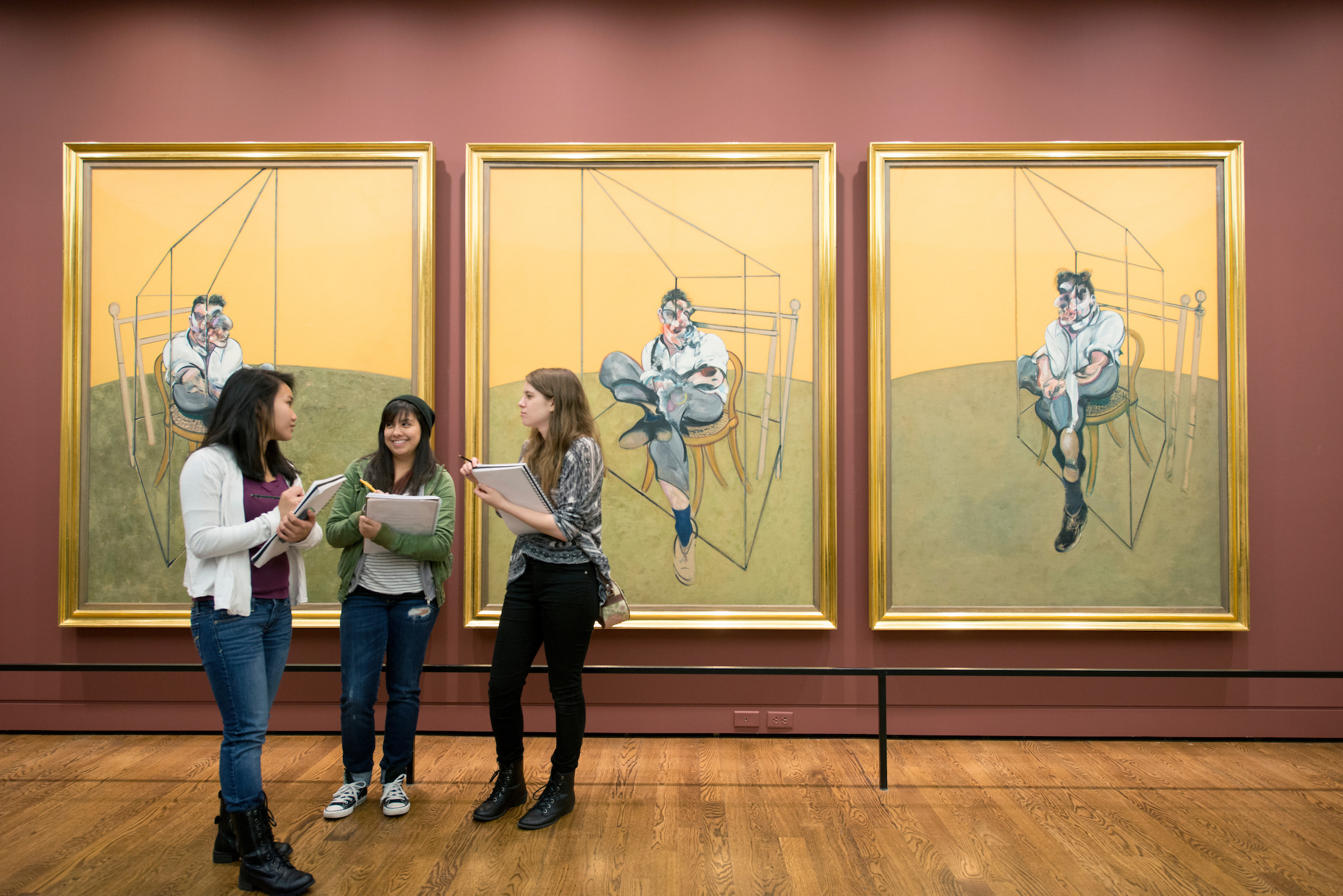 Art history students gathered in front of Francis Bacon paintings at the Portland Art Museum