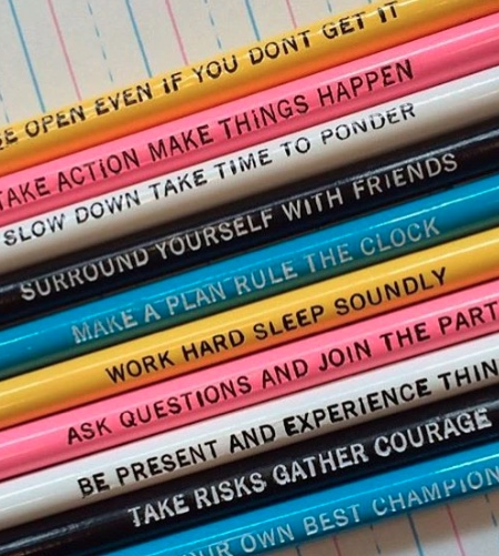 Colorful pencils with inspirational slogans printed on them