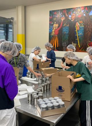Students helping volunteer at the Oregon Food Bank sorting food