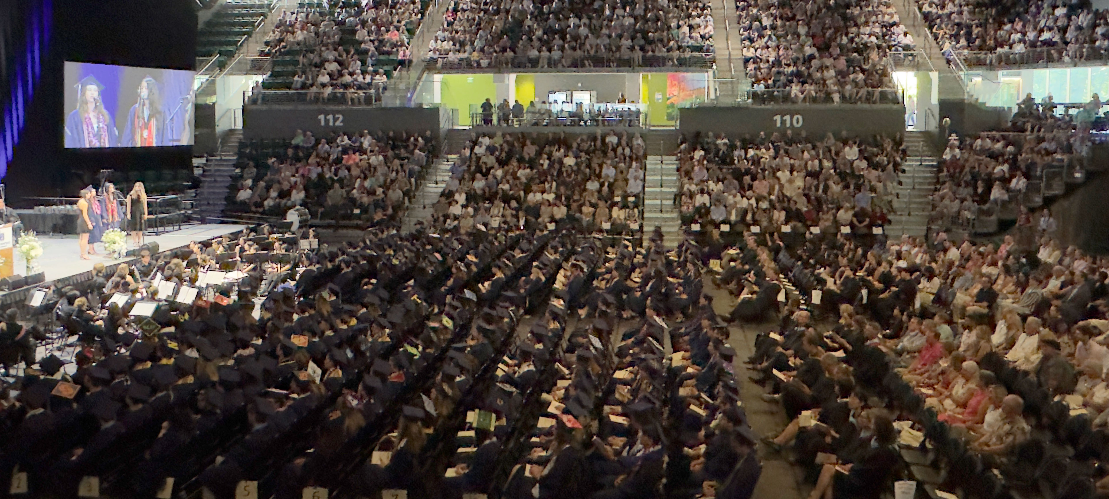 Attendees take part in a commencement ceremony in the Viking Pavilion Arena.