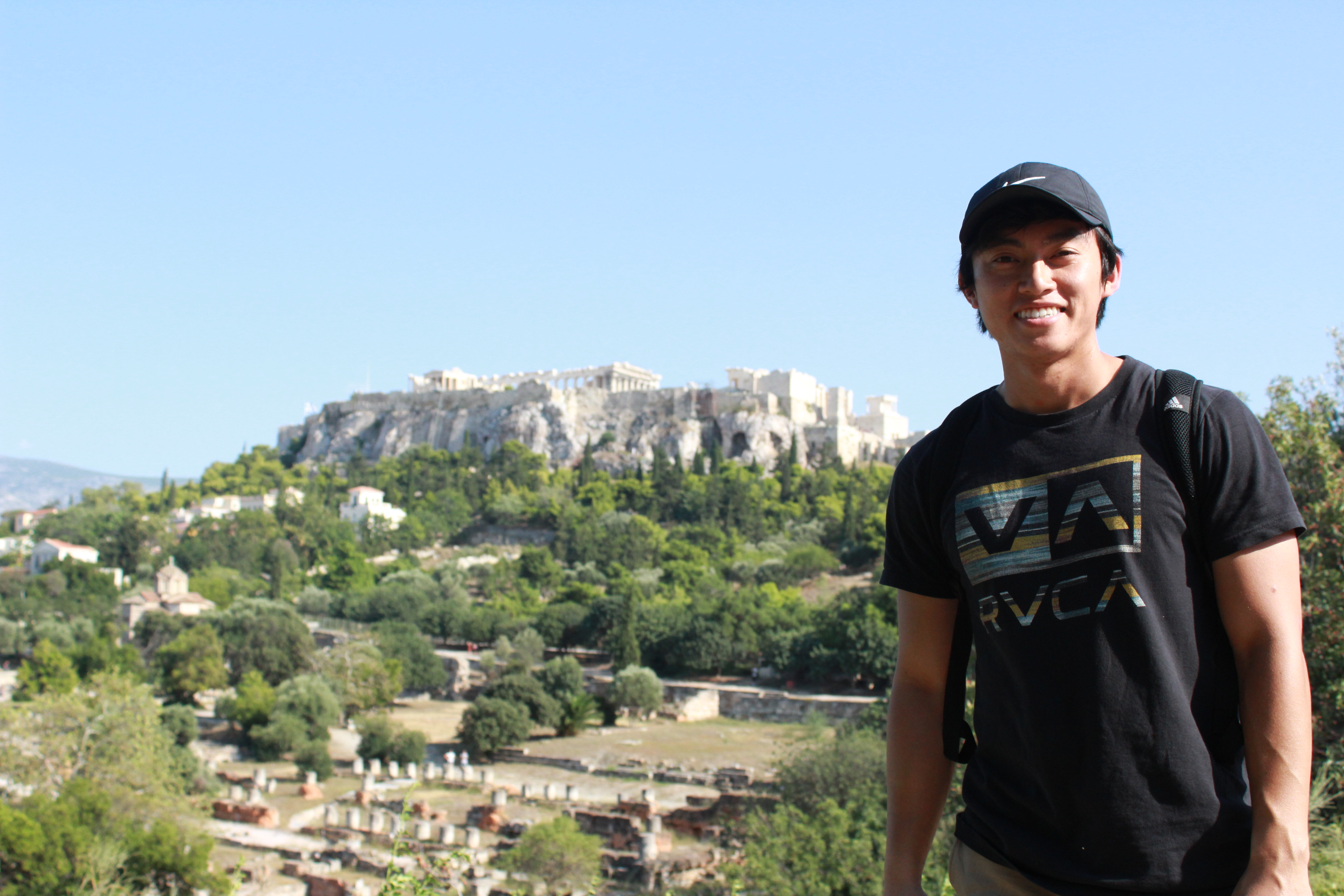PSU Student standing in front of the Acropolis in Greece