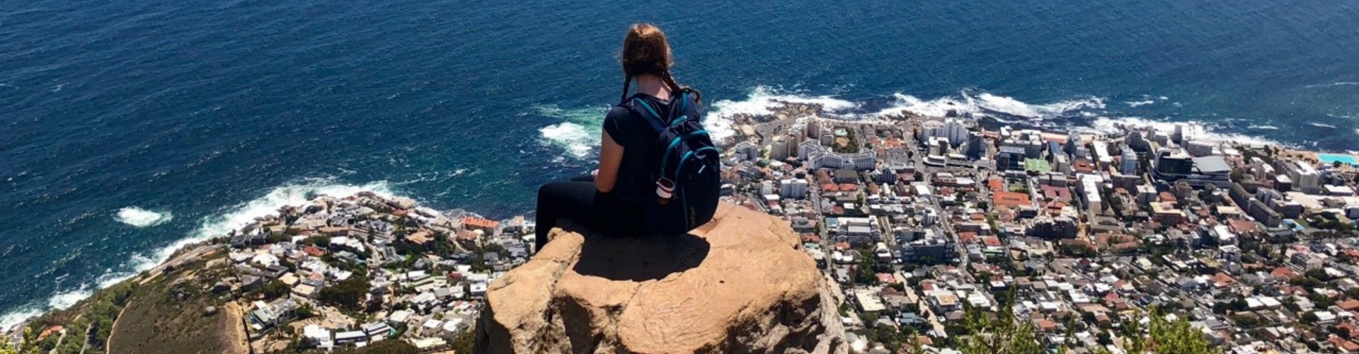 Student peched on Lions Head overlooking Table Bay in S. Africa