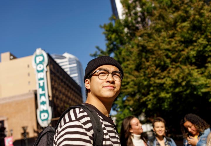Student next to Portland sign
