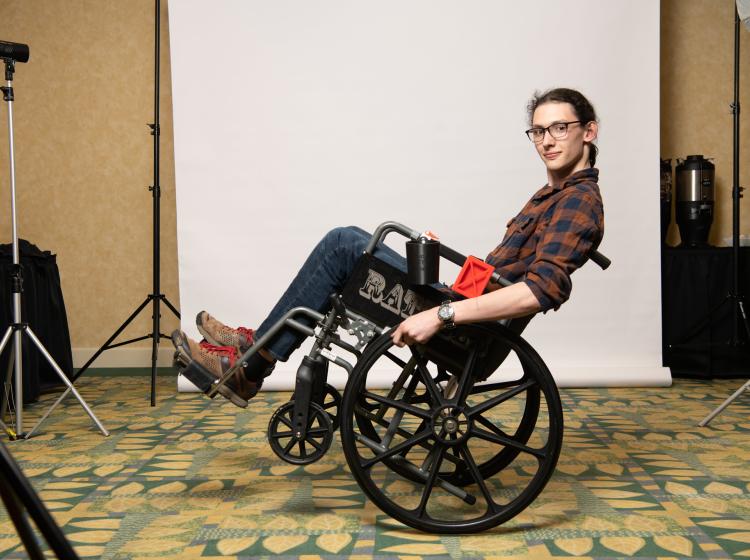 member of student entrepreneur team Wheelchair Mate showing off invention