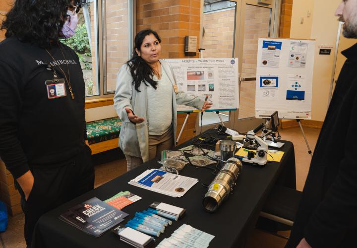 student presenting invention at an event