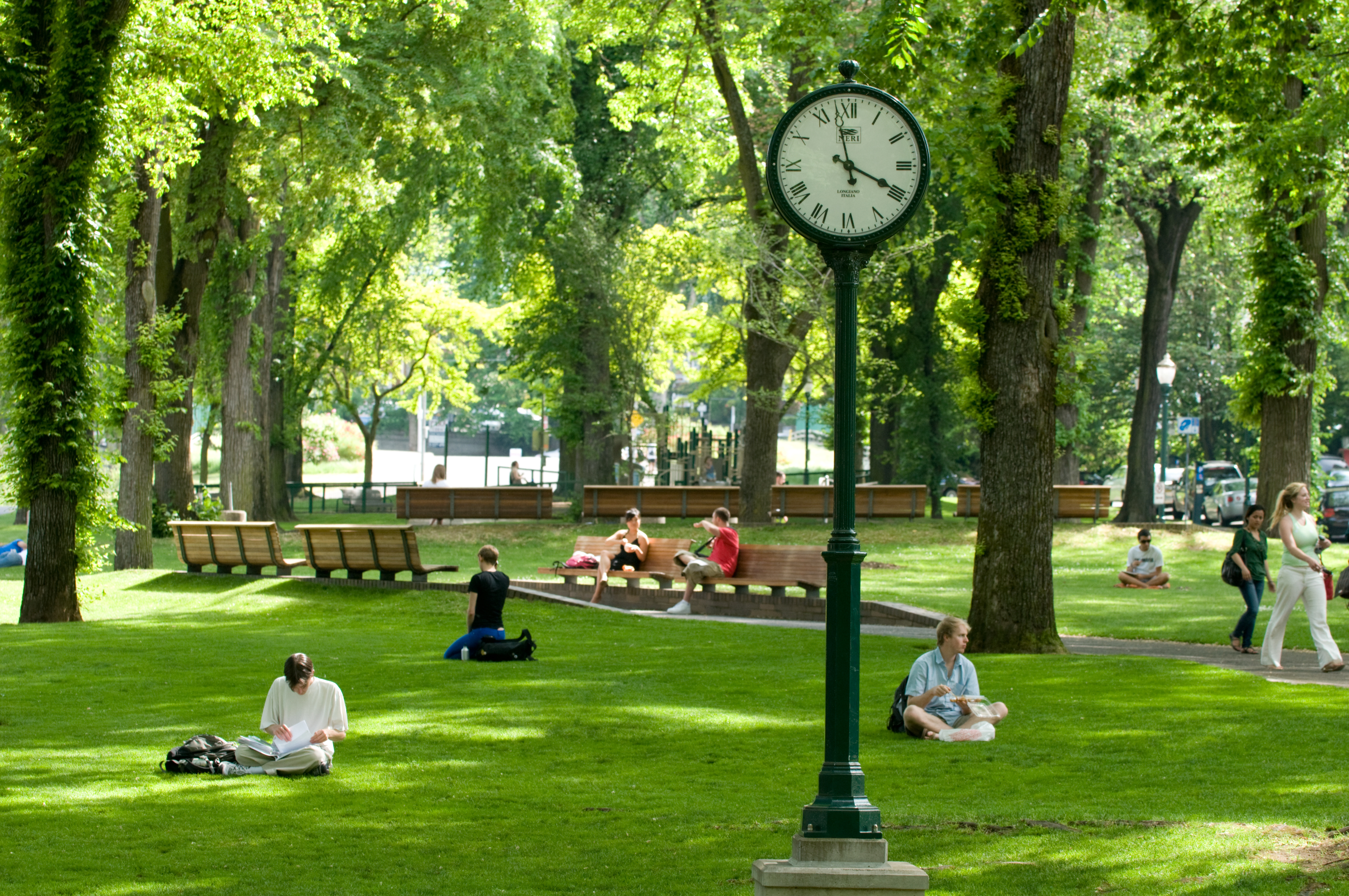 Photo of PSU Campus with students sitting in the lawn.