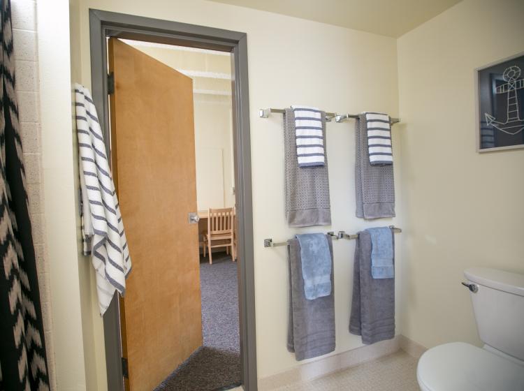 bathroom with shower in furnished studio suite