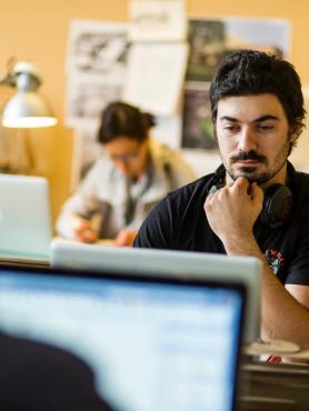 student thinking at computer