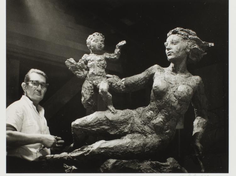 The artist is seen working on the sculpture in a black-and-white photo from 1965.