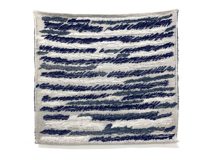 A square textile wall hanging patterned with abstract black, white and grey streaks resembling transmission static