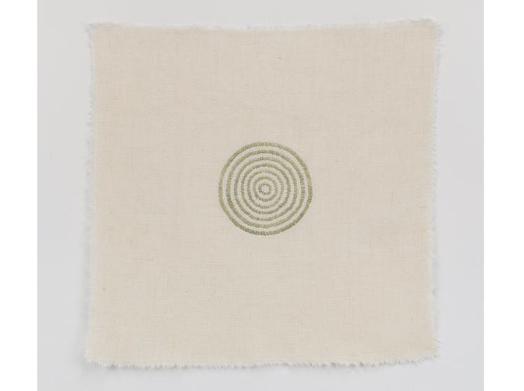 Stiched artwork with pale green concentric circles at center, on off-white background