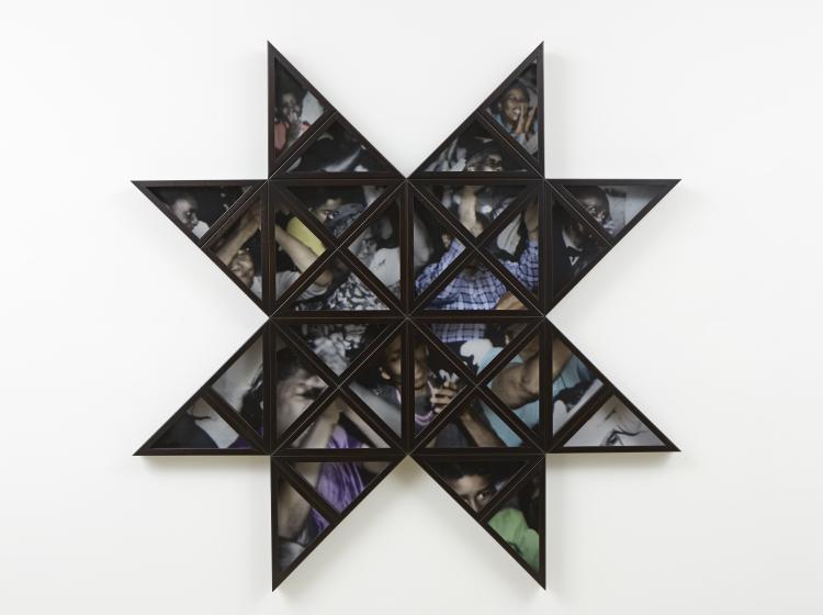 A star-shaped, multi-part frame containing a collage of photographic imagery, against a white wall