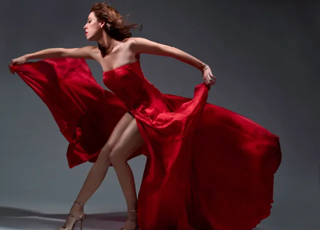 Opera singer and PSU alum Audrey Luna posing in a flowing red dress.