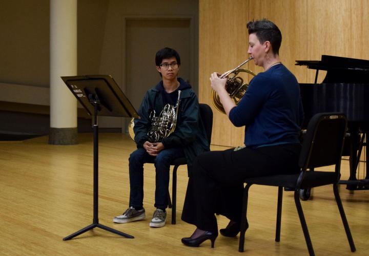 Brass student and teacher playing.